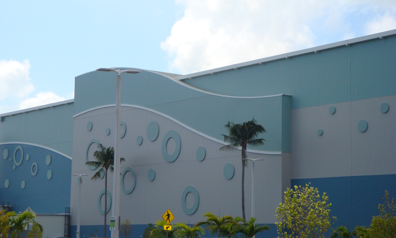 Florida approved wall panels in blue and gray on the haulover marine center in miami with palm trees in front