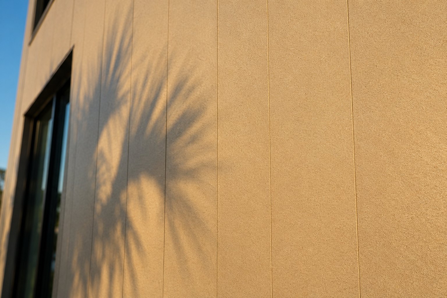 Close-up of florida approved wall panels showing the flat, lightly textured face and hairline vertical joints in late afternoon sun